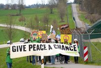 Teilnehmer des Ostermarsches laufen am 10.4.2023 am Zaun des Bundeswehr-Fliegerhorsts in Büchel vorbei. 